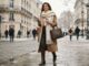The Ultimate Footwear & Accessory Guide for Fall & Winter Woman wearing a camel wool coat and a thick cream cashmere scarf