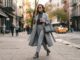How to Style Neutral Color Palettes for Maximum Impact Woman wearing tonal grey clothing including trousers and a grey coat